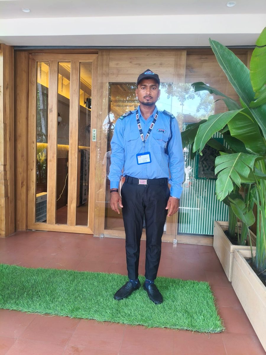 Uniformed guard at a building entrance