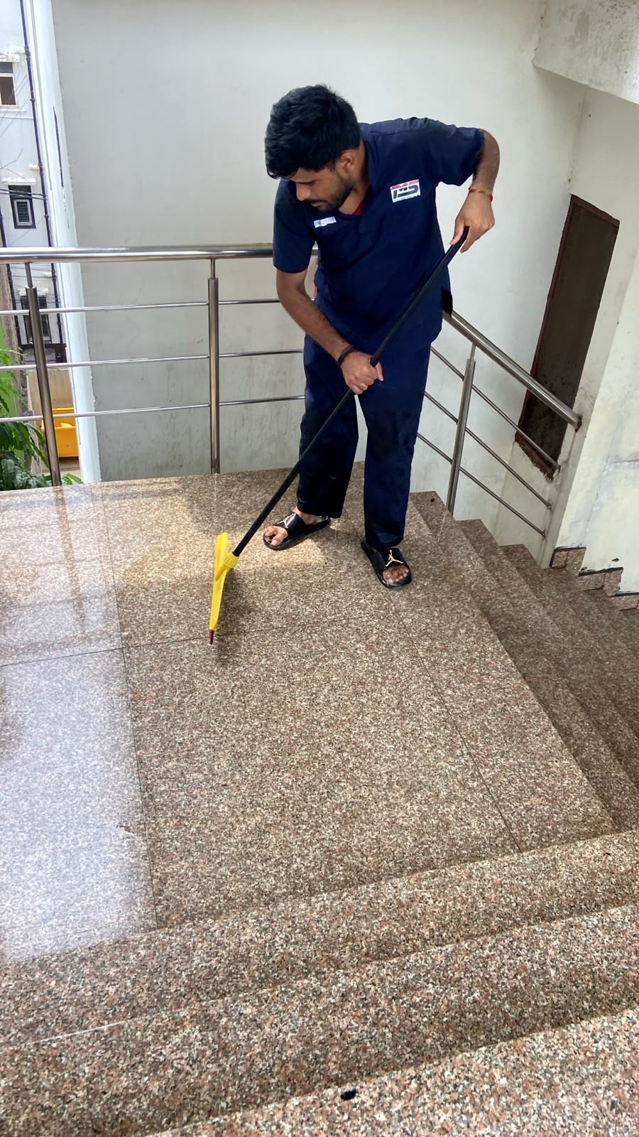 Housekeeping staff cleaning a staircase