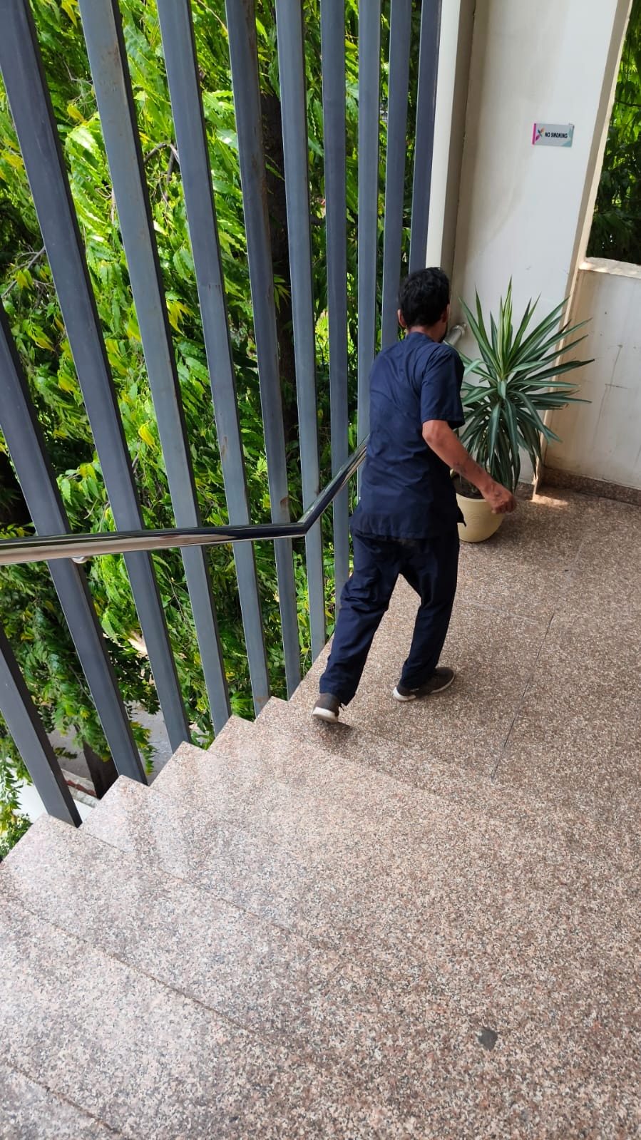 Housekeeping team member sweeping a stairway