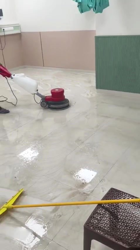 Floor machine polishing a hall